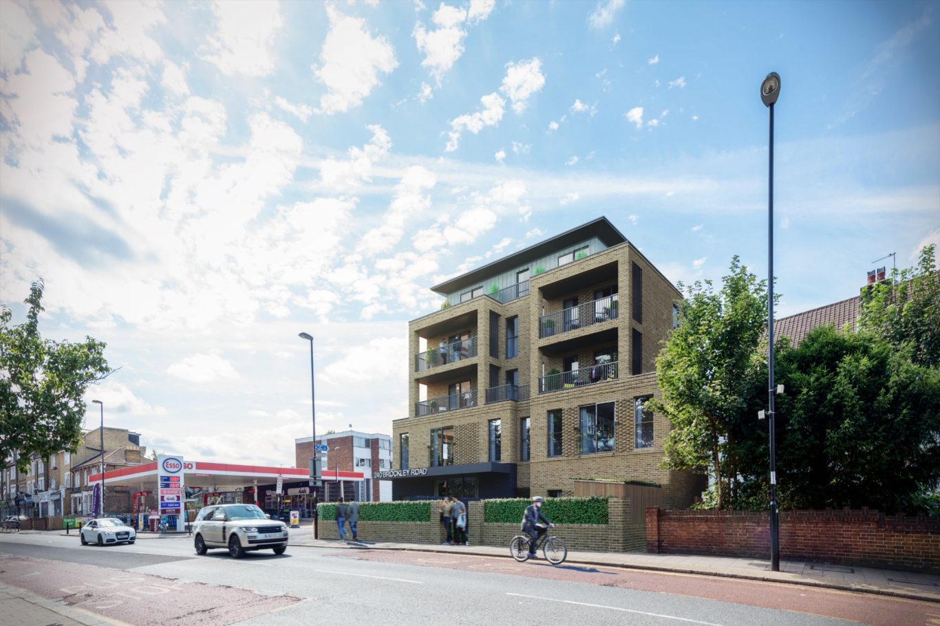Modern brick building with balconies, street view and clear blue sky.